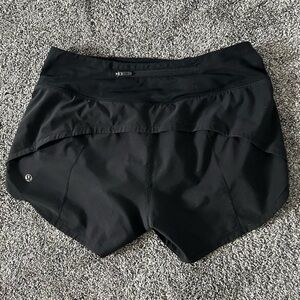 Black Lululemon Speedups • size 4 • 2.5” inseam • mid rise • minor flaw